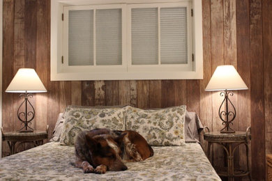 Small elegant guest dark wood floor and brown floor bedroom photo in Other with beige walls and no fireplace