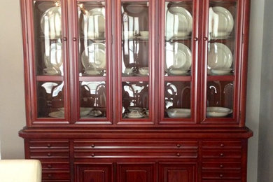 Mid-sized elegant medium tone wood floor and brown floor enclosed dining room photo in New York with white walls and no fireplace