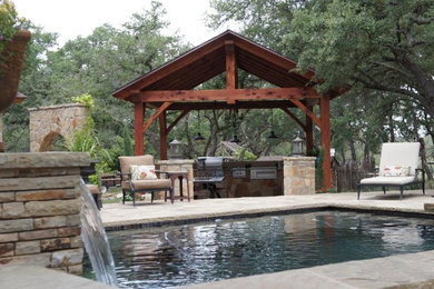 Example of a mid-sized mountain style backyard stone and rectangular lap pool fountain design in Austin
