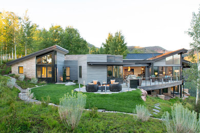 Trendy one-story mixed siding exterior home photo in Denver with a shed roof