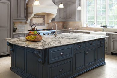 Enclosed kitchen - large transitional l-shaped travertine floor enclosed kitchen idea in Phoenix with a farmhouse sink, raised-panel cabinets, gray cabinets, marble countertops, beige backsplash, ceramic backsplash, stainless steel appliances and an island