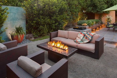 Photo of a mid-sized modern backyard patio in Portland with natural stone pavers and a fire feature.