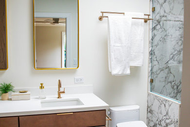 Alcove shower - small contemporary master black and white tile and porcelain tile porcelain tile and white floor alcove shower idea in Cincinnati with flat-panel cabinets, brown cabinets, a bidet, white walls, an undermount sink, quartz countertops, a hinged shower door, white countertops, a niche and a built-in vanity