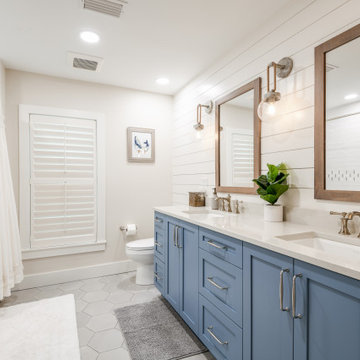 Blue vanity cabinetry gives this bath a fun edge.