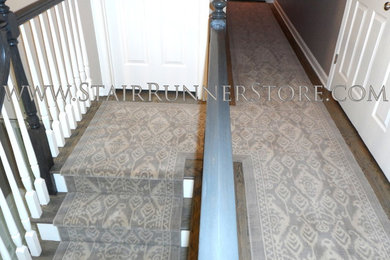 Photo of a large transitional hallway in New York with grey walls, grey floor and medium hardwood floors.