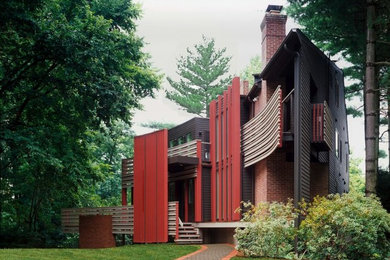 Inspiration for a large asian red two-story mixed siding exterior home remodel in DC Metro