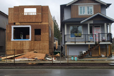 Inspiration for a mid-sized contemporary gray three-story vinyl and clapboard exterior home remodel in Vancouver with a shingle roof and a gray roof