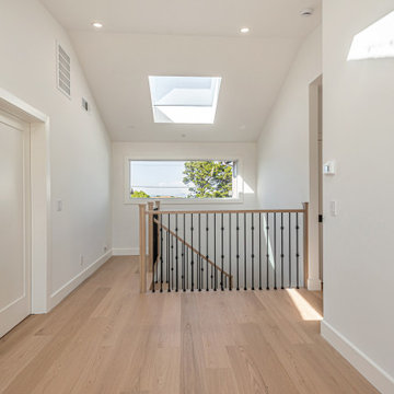 Spacious Second-Floor Landing Bathed in Natural Light from an Expansive Skylight