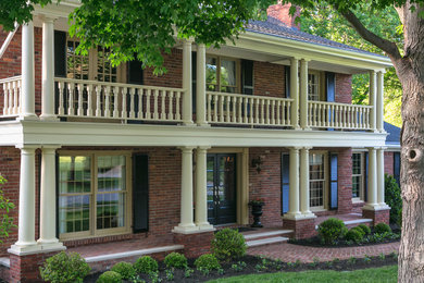 Photo of a traditional front yard verandah in Louisville with brick pavers.