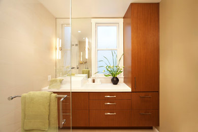Photo of a contemporary bathroom in San Francisco with a vessel sink, dark wood cabinets, beige walls and beige tile.