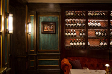 Example of a large classic carpeted, orange floor, coffered ceiling and wall paneling great room design in London with green walls, a standard fireplace and a stone fireplace