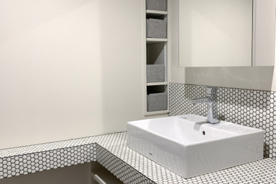 Design ideas for a small modern powder room in Tokyo Suburbs with white cabinets, beige walls, vinyl floors, a vessel sink, tile benchtops, grey floor, white benchtops and a built-in vanity.