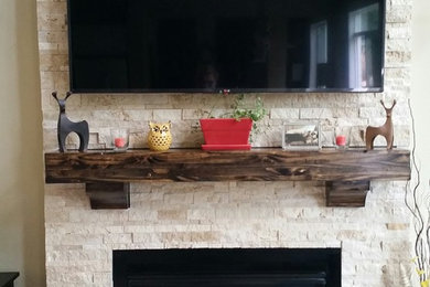Minimalist dark wood floor family room photo in Seattle with beige walls, a standard fireplace, a stone fireplace and a wall-mounted tv