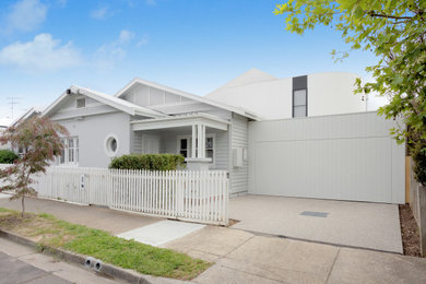 Inspiration for a mid-sized contemporary two-storey white house exterior in Geelong with concrete fiberboard siding, a gable roof, a metal roof and a white roof.