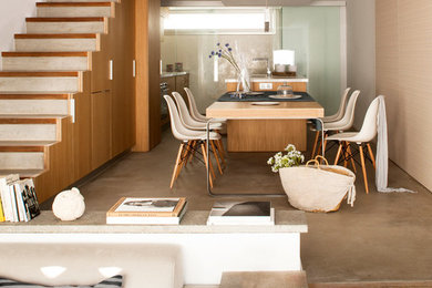 Photo of a large scandinavian open plan dining in Barcelona with beige walls, concrete floors and no fireplace.