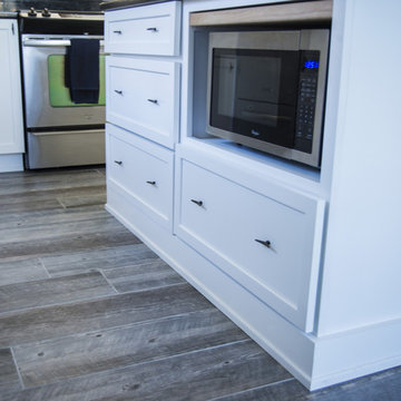Clean White Cabinets with Small Bar and Microwave Under Counter