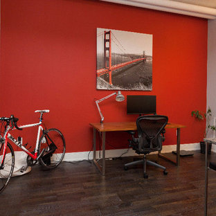 Inspiration for a small modern study in Toronto with red walls, dark hardwood flooring, no fireplace, a freestanding desk and brown floors.