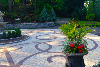 Photo of a large traditional full sun front yard brick landscaping in Providence.