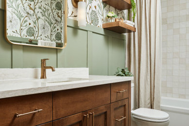 Bathroom - mid-sized transitional master white tile and ceramic tile porcelain tile, beige floor, single-sink and wainscoting bathroom idea in Minneapolis with recessed-panel cabinets, medium tone wood cabinets, a one-piece toilet, green walls, a drop-in sink, quartz countertops, white countertops, a niche and a freestanding vanity