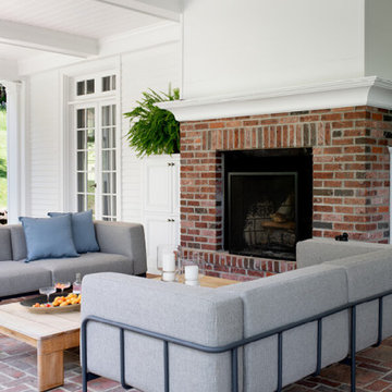 Classic Porch with Brick Fireplace, Columns, and French Doors