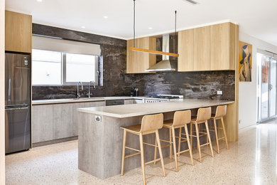 Large modern u-shaped kitchen pantry in Melbourne with an undermount sink, flat-panel cabinets, grey cabinets, quartz benchtops, brown splashback, ceramic splashback, stainless steel appliances, concrete floors, with island and grey benchtop.