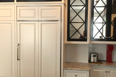 Example of a large transitional kitchen design in Philadelphia with raised-panel cabinets, white cabinets and granite countertops