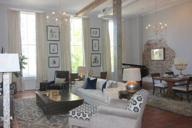 Living room - mid-sized industrial loft-style medium tone wood floor and brown floor living room idea in Atlanta with a music area, gray walls and no fireplace