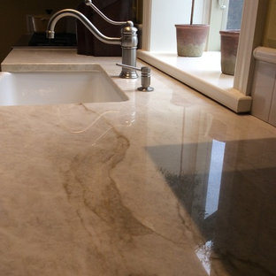 Large kitchen pantry inspiration - Large galley kitchen pantry photo in Birmingham with a farmhouse sink, recessed-panel cabinets, white cabinets, quartzite countertops, yellow backsplash, glass tile backsplash, stainless steel appliances and an island