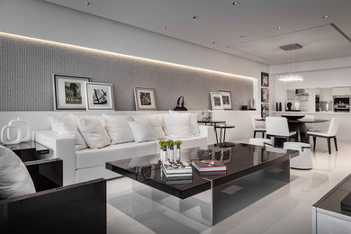 Large contemporary formal open concept living room in Miami with white walls, porcelain floors, a wall-mounted tv, no fireplace and white floor.