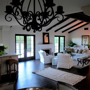 Mittelgroßes Mediterranes Wohnzimmer im Loft-Stil mit weißer Wandfarbe, dunklem Holzboden, Kamin, Kaminsims aus Beton und braunem Boden in Santa Barbara