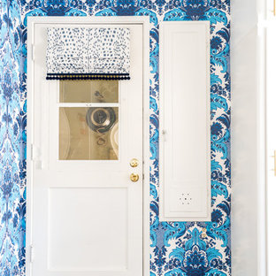 Small eclectic galley separated utility room in Los Angeles with a belfast sink, flat-panel cabinets, white cabinets, tile countertops, blue walls, vinyl flooring, a stacked washer and dryer, brown floors and yellow worktops.