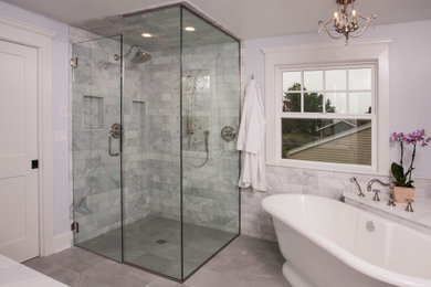 Inspiration for a large timeless master white tile and marble tile porcelain tile, gray floor, double-sink and wainscoting bathroom remodel in Seattle with shaker cabinets, white cabinets, a two-piece toilet, blue walls, an undermount sink, quartz countertops, a hinged shower door, white countertops, a niche and a freestanding vanity