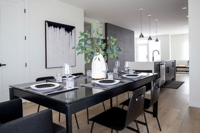 Inspiration for a small modern kitchen/dining combo in Vancouver with white walls and medium hardwood floors.