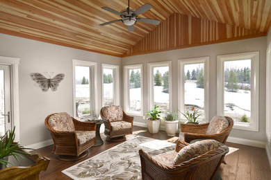 Example of a mid-sized beach style medium tone wood floor and brown floor sunroom design in Edmonton with a standard ceiling