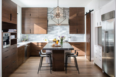 Kitchen - contemporary u-shaped dark wood floor kitchen idea in San Diego with an undermount sink, flat-panel cabinets, dark wood cabinets, gray backsplash, matchstick tile backsplash, stainless steel appliances and an island