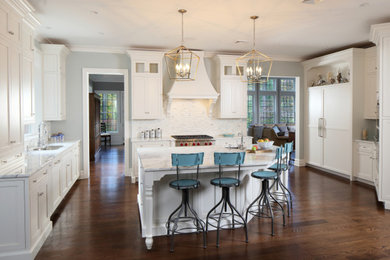 Example of a mid-sized transitional u-shaped medium tone wood floor and brown floor enclosed kitchen design in New York with an undermount sink, beaded inset cabinets, white cabinets, marble countertops, white backsplash, stainless steel appliances, an island, white countertops and porcelain backsplash