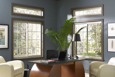 Example of a mid-sized trendy freestanding desk light wood floor and beige floor study room design in Salt Lake City with blue walls