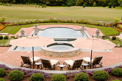 Inspiration for a large timeless backyard brick and custom-shaped lap hot tub remodel in Philadelphia