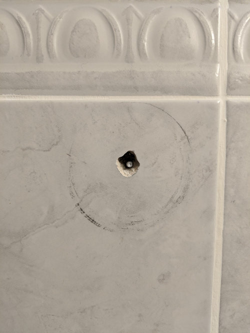 Bathroom towel and toilet paper holder broke off.