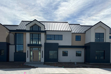 Large modern two-story mixed siding house exterior idea in Boise with a black roof