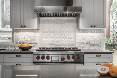 Eat-in kitchen - large craftsman galley cork floor and beige floor eat-in kitchen idea in Toronto with a drop-in sink, recessed-panel cabinets, beige cabinets, concrete countertops, beige backsplash, ceramic backsplash, stainless steel appliances, an island and gray countertops