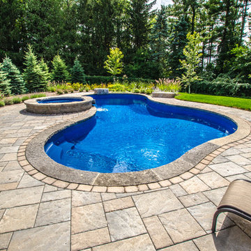 Custom curved pool with spillover hot tub - Georgetown