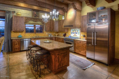Large southwest l-shaped ceramic tile eat-in kitchen photo in Phoenix with a double-bowl sink, raised-panel cabinets, medium tone wood cabinets, granite countertops, yellow backsplash, ceramic backsplash, stainless steel appliances and an island