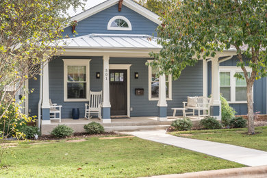 Example of an arts and crafts blue one-story mixed siding and clapboard exterior home design in Austin with a shingle roof