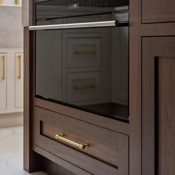Custom Walnut and White Kitchen Remodel with Marble Slab Backsplash and Brass Ac