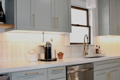 Open concept kitchen - mid-sized modern galley porcelain tile and green floor open concept kitchen idea in Houston with an undermount sink, shaker cabinets, green cabinets, quartz countertops, white backsplash, porcelain backsplash, stainless steel appliances and white countertops