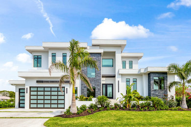 Example of a trendy white two-story exterior home design in Tampa