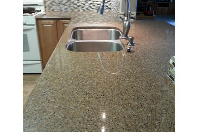 Small elegant u-shaped linoleum floor kitchen pantry photo in Other with an undermount sink, raised-panel cabinets, medium tone wood cabinets, quartzite countertops, brown backsplash, mosaic tile backsplash, white appliances and no island