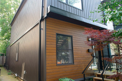 Mid-sized scandinavian black two-story mixed siding and board and batten exterior home idea in Toronto with a shingle roof and a black roof