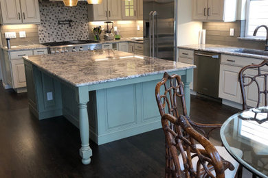 Mid-sized medium tone wood floor and brown floor kitchen photo in Denver with an undermount sink, granite countertops, gray backsplash, glass tile backsplash, stainless steel appliances, an island and multicolored countertops
